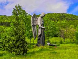 wood angel statue in forest