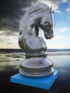 Sculpture of horse chess figure on water