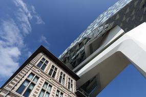 Shiny office building, with the windows, in Antwerp, Belgium, under the blue sky with white vlouds