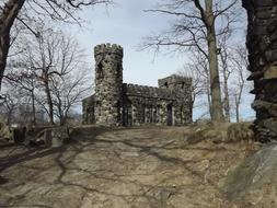 Beautiful, stone castle, among the trees on landscape