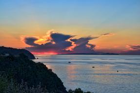 Beautiful landscape with the shore of Trilye, Turkey, at colorful sunset in the sky with clouds