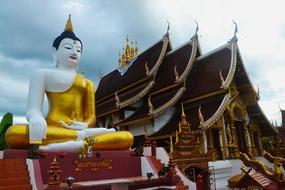 ancient buddha statue on the background of a temple in Bangkok, Thailand