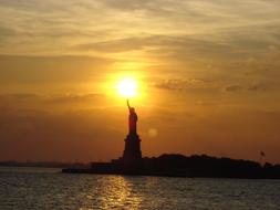 distant view of the Statue of Liberty at dusk