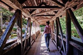 Traveler on Wooden Bridge