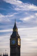 Beautiful Big Ben clock on the tower, in London, England, United Kingdom, under the blue sky with white clouds