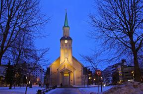 illuminated church and blue sky at night