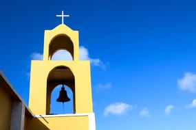 bell in the tower in the church against the blue sky