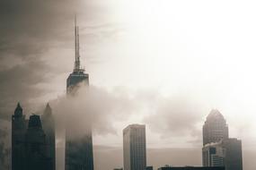 City with skyscrapers among the clouds, in light