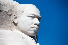Portrait of the man, in the white rock, at blue sky on background