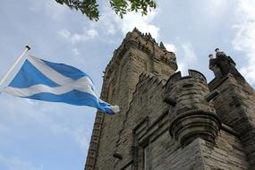 Beautiful tower of Wallace, in Scotland, with the blue and white flag