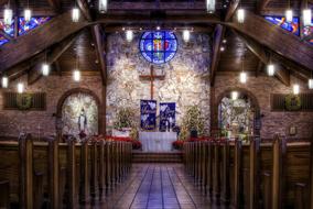 Beautiful Sanctuary of the church, with lights and colorful stained glass windows