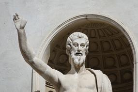 statue of a man with a beard with a raised hand