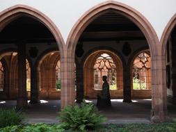 Person in the beautiful Basel cathedral with arches in MÃ¼nster, Germany