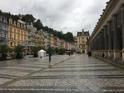 Beautiful and colorful street in Karlovy Vary, Czech Republic, under the clouds, with the rain