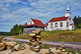 Beautiful church, among the colorful plants and rocks in New Brunswick, Canada