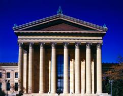 Beautiful Museum of Art, with the columns, in Philadelphia, Pennsylvania, USA, near the colorful trees, at blue sky on background