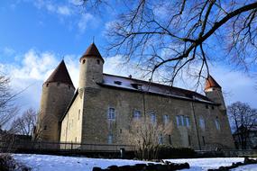 Beautiful castle among the trees in snow in winter in Switzerland