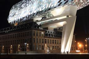 Beautiful, shiny office building and street with lights in Antwerp, Belgium