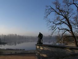 statue over water in a picturesque landscape