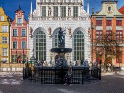 statue with a fountain near the building