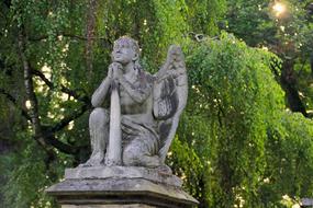 Cemetery Sculpture under green trees