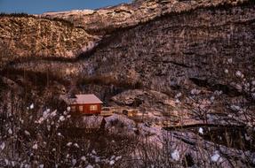 Red house in the beautiful mountains at beautiful sunset