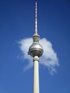 Close-up of the tv tower, at blue sky with white clouds on background, in Berlin, Germany