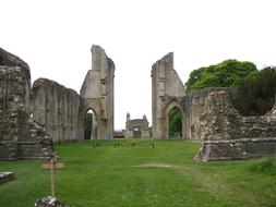 green fields near the ruins of buildings in england