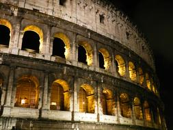 lights in the windows in the colosseum at night