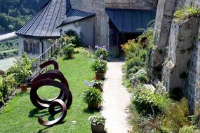 Beautiful castle with the colorful garden with plants and flowers, on the mountain