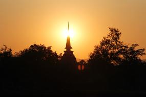 spire of the temple complex at sunset in Thailand