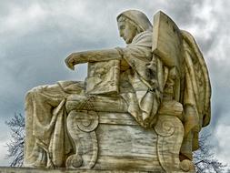 Old Contemplation Of Justice statue at cloudy sky in Washington DC, USA