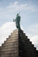 Beautiful building with the statue, at blue sky with white clouds, in Copenhagen, Denmark