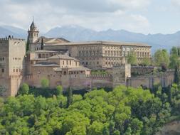 Beautiful Alhambra, among the green trees and mountains, in Granada, Spain