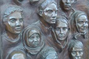 the faces of the people on the sculpture