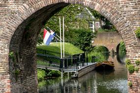 Beautiful coast of Zutphen with the bridge and flags at the canal in Netherlands