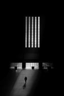 black and white man near the building in the dark