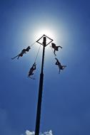 Papantla Flyers in Mexico, under the blue sky, in sunlight