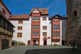 Beautiful Ronneburg with colorful buildings at blue sky with white clouds on background in Hesse, Germany