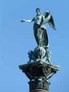 bronze statue with wings against the sky