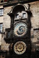 Close-up of the beautiful, shiny, vintage clock on the wall in Prague, Czech Republic