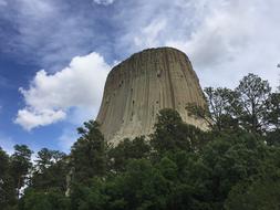 Beautiful landscape of Devils Tower, among the green trees in Wyoming, USA