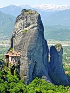 green plants near the big rock in greece