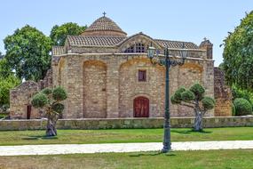 Beautiful and colorful Panagia Angeloktisti in Kiti, Cyprus, Greece, among the colorful plants