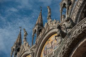 Beautiful and colorful, decorated church in Venice, Italy, at blue sky with white clouds on background