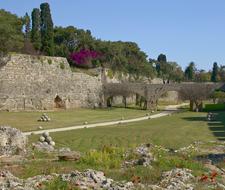 Beautiful landscape of the fortress with moat, among the colorful plants, on Rhodes, Greece