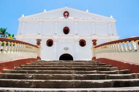 steps in front of the white architecture of the temple