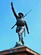 statue of a soldier on a background of a light blue sky