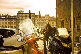 Beautiful, retro landscape of Florence, Italy, with people and vehicles, among the buildings, at beautiful sunset