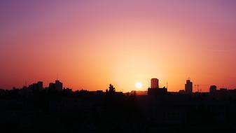 silhouette of the city skyline during sunset